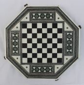 A 19th century Indian ivory, ebony and sadeli work chess board of octagonal form,