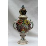 A Dresden porcelain vase and cover applied with flower heads and leaves,