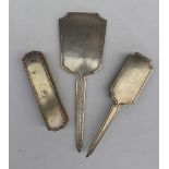 A Chinese white metal part dressing table set, comprising a hand mirror,
