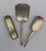 A Chinese white metal part dressing table set, comprising a hand mirror,