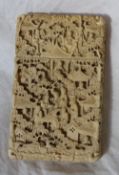 A 19th century Cantonese carved ivory card case, carved with figures trees and dwellings, 10.8 x 6.
