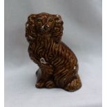 An E Jenkins Ewenny Pottery seated spaniel, with a mustard glaze and moulded body,