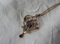 An Edwardian amethyst and seed pearl pendant of heart shape on a 9ct yellow gold chain,