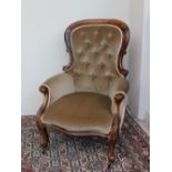 A Victorian mahogany framed Gentleman's chair with a button upholstered back,