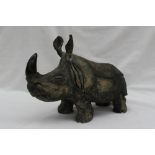 A John Hughes Pottery model of a Rhinoceros, signed on the foot,