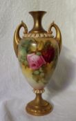 A Royal Worcester porcelain twin handled vase, with a flared neck,