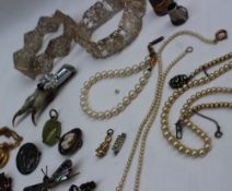 Assorted costume jewellery including faux pearl necklaces and bracelet, silver dragonfly brooch,