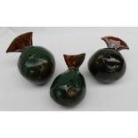 A set of three John Hughes pottery bird money boxes, of globe shape decorated in greens and browns,