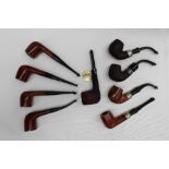 A collection of nine new, boxed Peterson pipes, one with a silver collar.