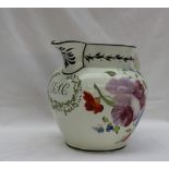 A 19th century pottery creamware jug painted with roses and other flowers, bears the initials T.J.C.