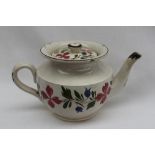 A 19th century English pottery miniature teapot, decorated with a garland of flowers,