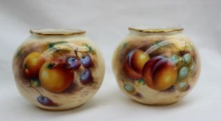 A pair of Royal Worcester vases of spherical form, one painted with apples and grapes,
