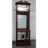 A mahogany shop display cabinet, the moulded cornice above two glazed doors and glazed sides,