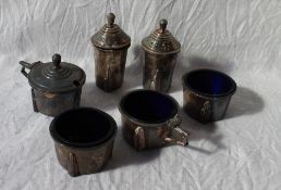 A white metal cruet comprising two pepperettes, two open salts and two mustard pots,