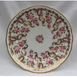 A Nantgarw porcelain plate with a gilt scalloped border,