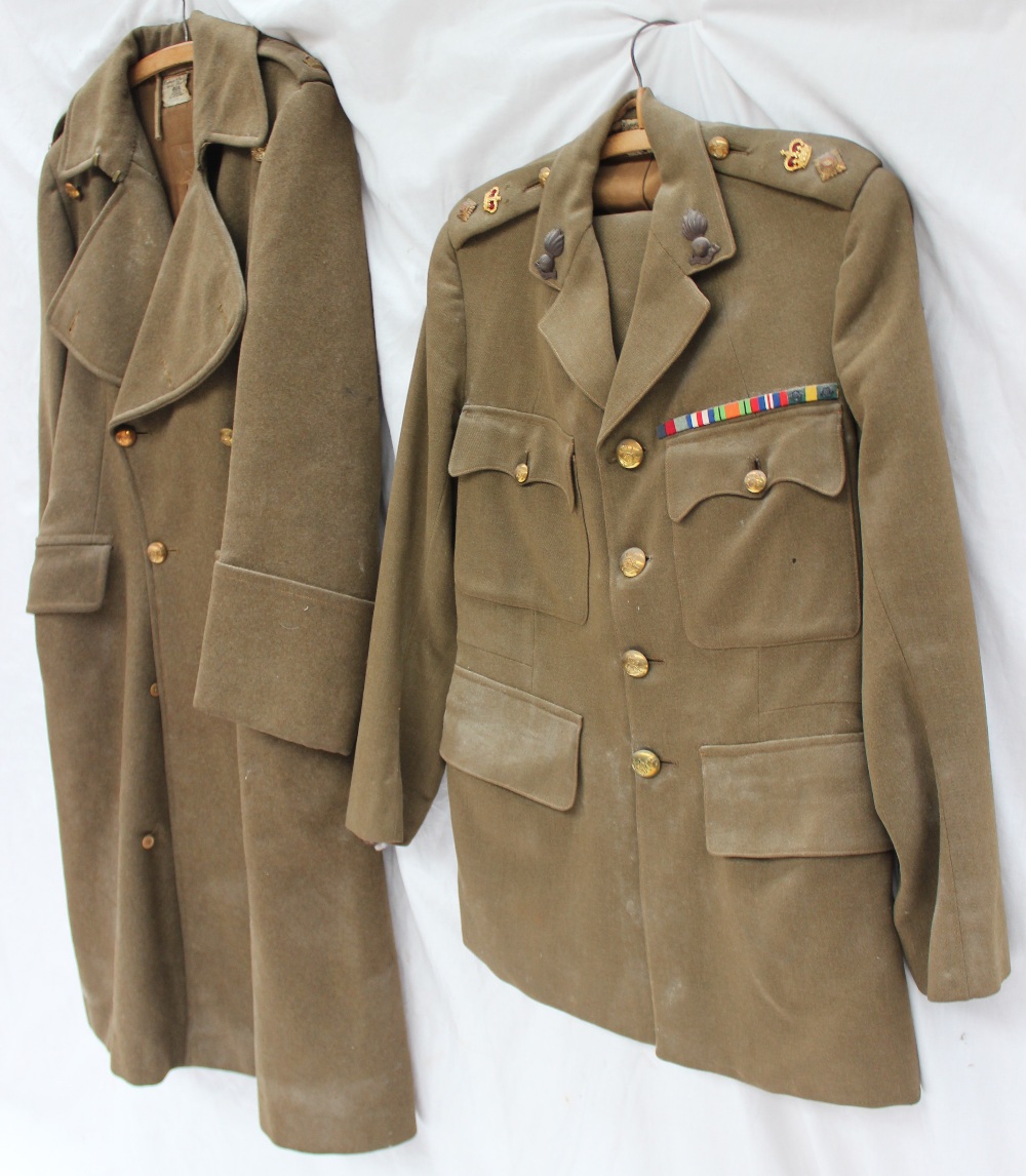 A World War II military uniform, with 'UBIQUE" Royal Artillery badges, military buttons,
