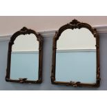 A pair of gilt gesso easel mirrors, with a scrolling cresting rail and leaf decoration,