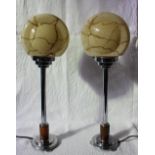 A pair of Art Deco style table lamps, with circular marbled glass shades,