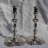 A pair of Elizabeth II silver candlesticks with a turned sconce and knopped stem with a spreading