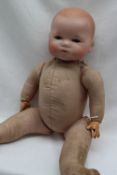 An Armand Marseille bisque head doll with moulded hair, closing blue eyes, to a fabric body,
