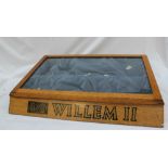 An oak table top display cabinet with a sliding glass door, stencilled to the front "Willem II",