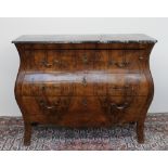 A 20th century continental walnut bombe commode the marble top above three graduated drawers on