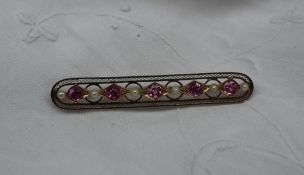 A pearl and pink sapphire bar brooch,