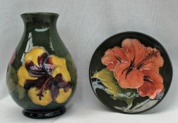 A Moorcroft pottery vase decorated with flowers to a green ground,