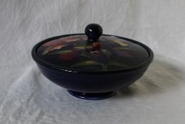 A Moorcroft powder pot and cover of squat circular form, the lid with a central knop,