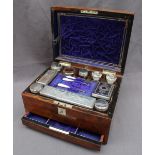 A Victorian walnut Lady's travelling box, of rectangular form inset with a mother of pearl shield,
