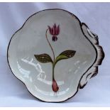 A 19th century pottery dish painted with a Dogs Tooth Violet,