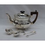 An Edward VII silver teapot, of oval form on ball feet, Birmingham, 1904,