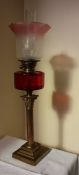 A Victorian cranberry glass oil lamp,