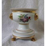 A 19th century continental porcelain vase with a flared rim, applied with gilt masks,