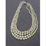 A four strand pearl necklace set with graduated pearls to a 9ct gold pearl set clasp,