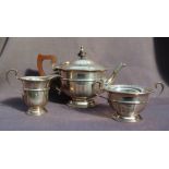 A George V silver three piece tea set, with a panelled body on a spreading foot, Birmingham, 1931,