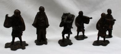 A set of six Oriental bronze figures, depicting men in traditional dress wearing samurai swords,