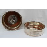 A pair of silver wine coasters of plain circular form with everted rims,