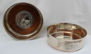 A pair of silver wine coasters of plain circular form with everted rims,