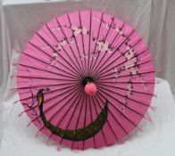 A Chinese parasol, decorated with a peacock, and flowers,