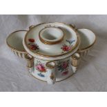 A 19th century English porcelain inkwell, with a central well, pen holders and two well,