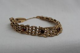 A 9ct yellow gold and garnet set bracelet,