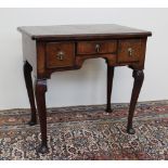 An 18th century and later walnut lowboy, the rectangular top with quarter veneers,