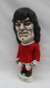 A John Hughes pottery Grogg of George Best, in a red Jersey for Man Utd,