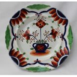 A Dillwyn Swansea pottery plate decorated with a vase of flowers,