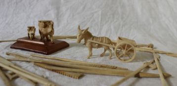 An Indian ivory figure group of two camels together with a donkey and cart and bone and ivory