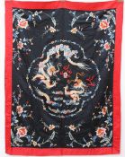 A Chinese silk wall hanging / throw, decorated with dragons flowers and leaves,