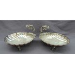 A pair of continental white metal shell shaped dishes,