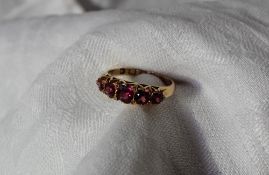 An 18ct yellow gold line ring set with five pink Tourmalines
