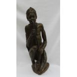 An African hardstone figure of a seated figure smoking a pipe,